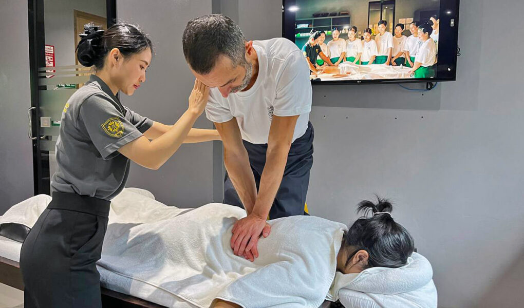 Assistant trainer Nigel Amonrat Paojae instructing student Ivan Kralj during the Thai massage course at Thai Oasis Spa School in Chiang Mai, Thailand.