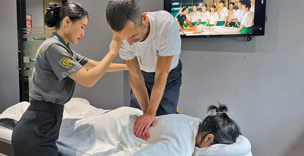 Assistant trainer Nigel Amonrat Paojae instructing student Ivan Kralj during the Thai massage course at Thai Oasis Spa School in Chiang Mai, Thailand.