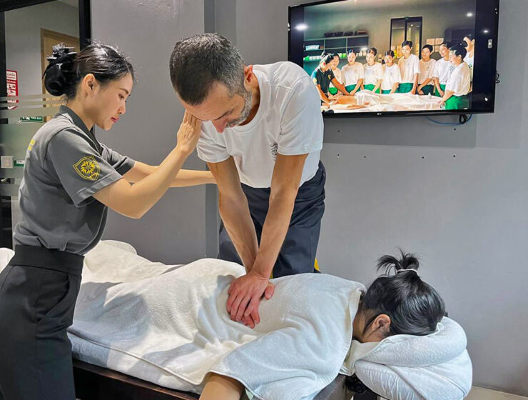 Assistant trainer Nigel Amonrat Paojae instructing student Ivan Kralj during the Thai massage course at Thai Oasis Spa School in Chiang Mai, Thailand.