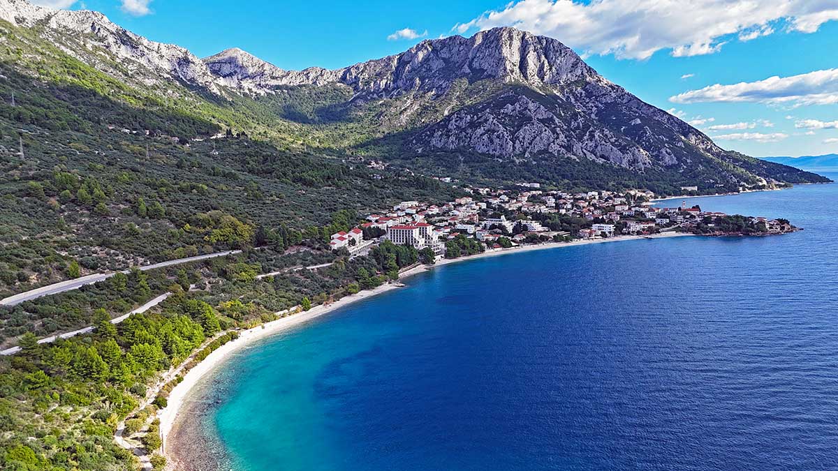 Gradac FKK Beach, a naturist haven with Biokovo Mountain as backfdrop, on Makarska Riviera, Croatia; photo by Ivan Kralj.