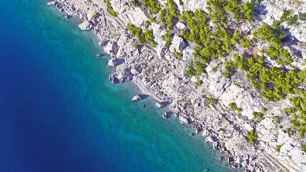 Aerial view of Krvavica FKK Beach, one of the favorite naturist beaches for gay visitors on Makarska Riviera, Croatia; photo by Ivan Kralj.