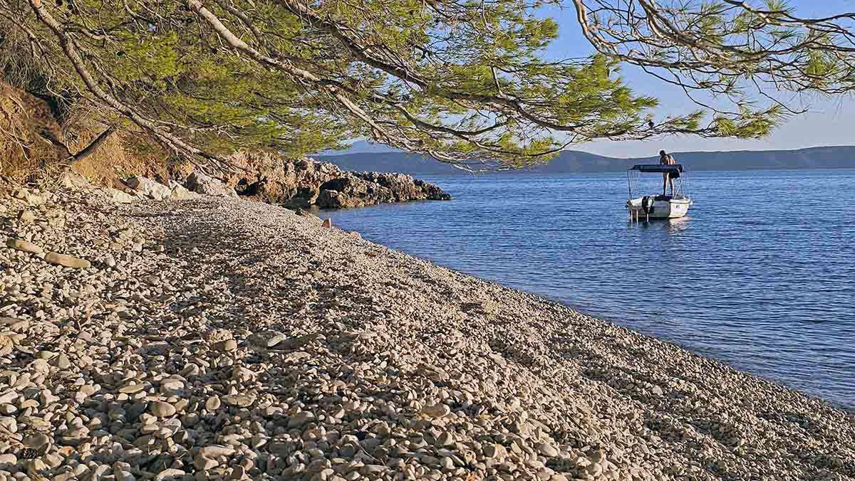 A nudist on a boat anchored at Middle Wild Beach, a naturist pebble stretch between Igrane and Drašnice, Makarska Riviera, Croatia; photo by Ivan Kralj.