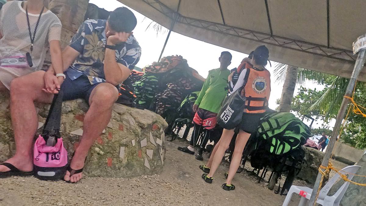 Half-sleepy tourists at life vest collection point at Oslob whale shark watching site in Tan-awan, Cebu Island, the Philippines; photo by Ivan Kralj.