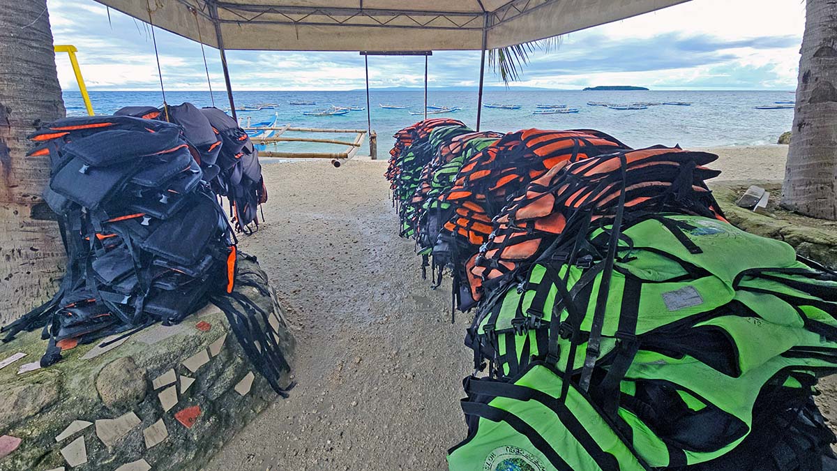A huge pile of life vests on the beach of Tan-awan, where Oslob whale shark watching operation is conducted, on Cebu Island, the Philippines; photo by Ivan Kralj.