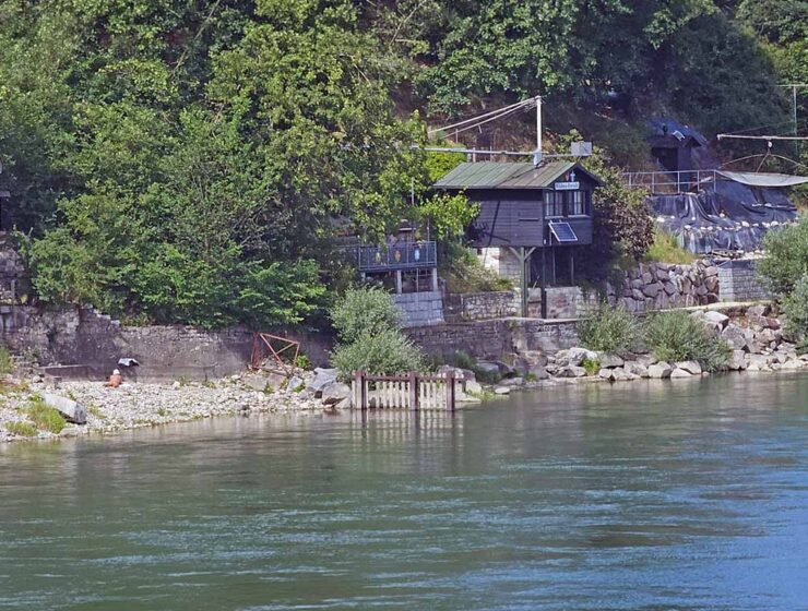 A naked man relaxing on an FKK beach beneath the Grenzacher-Promenade in Basel, Switzerland; photo by Ivan Kralj.