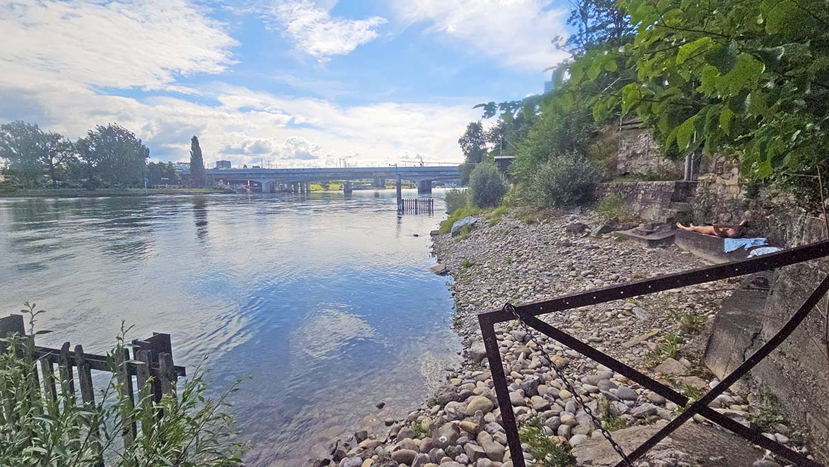 A male naturist sunbathing by the Rhine, beneath the Grenzacher Promenade, in the vicinity of Rankhof stadium in Basel, Switzerland; photo by Ivan Kralj.