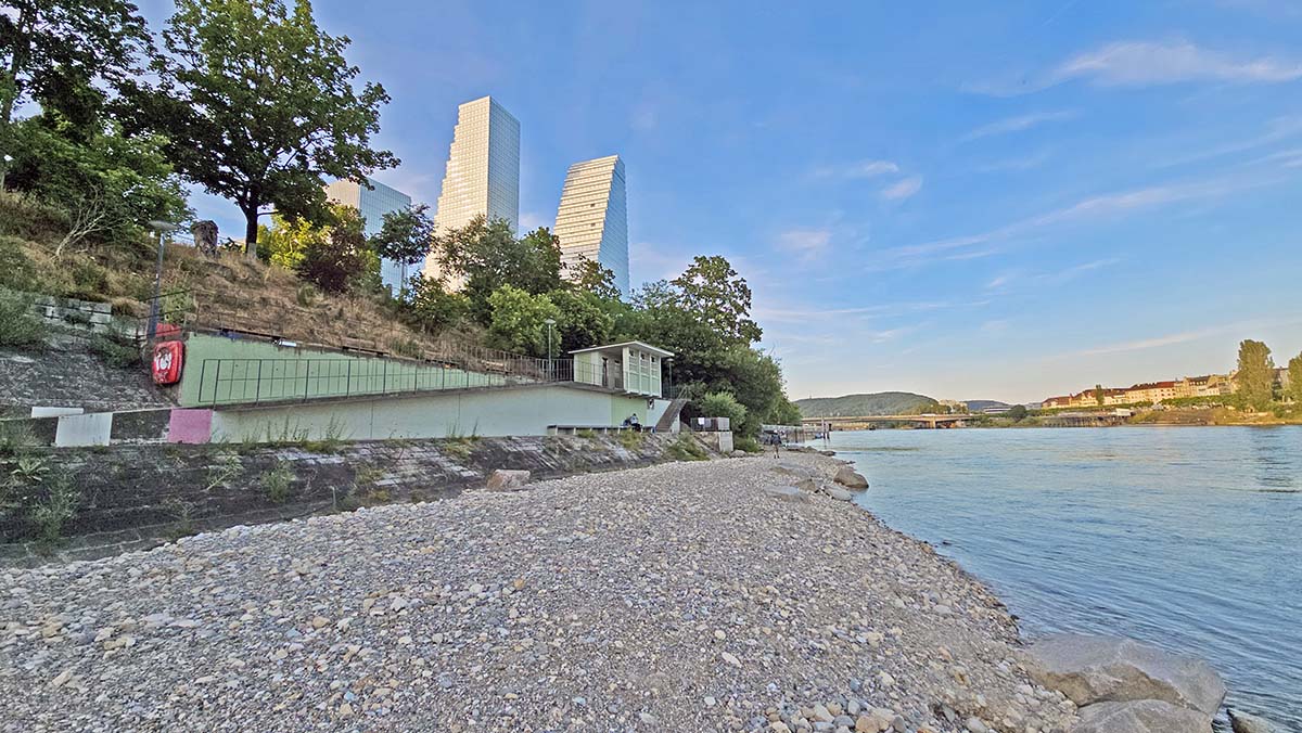 Sunset at the Naturistenstrand Basel-Stadt, the city's nudist beach beneath Roche Towers in Basel, Switzerland; Photo by Ivan Kralj.