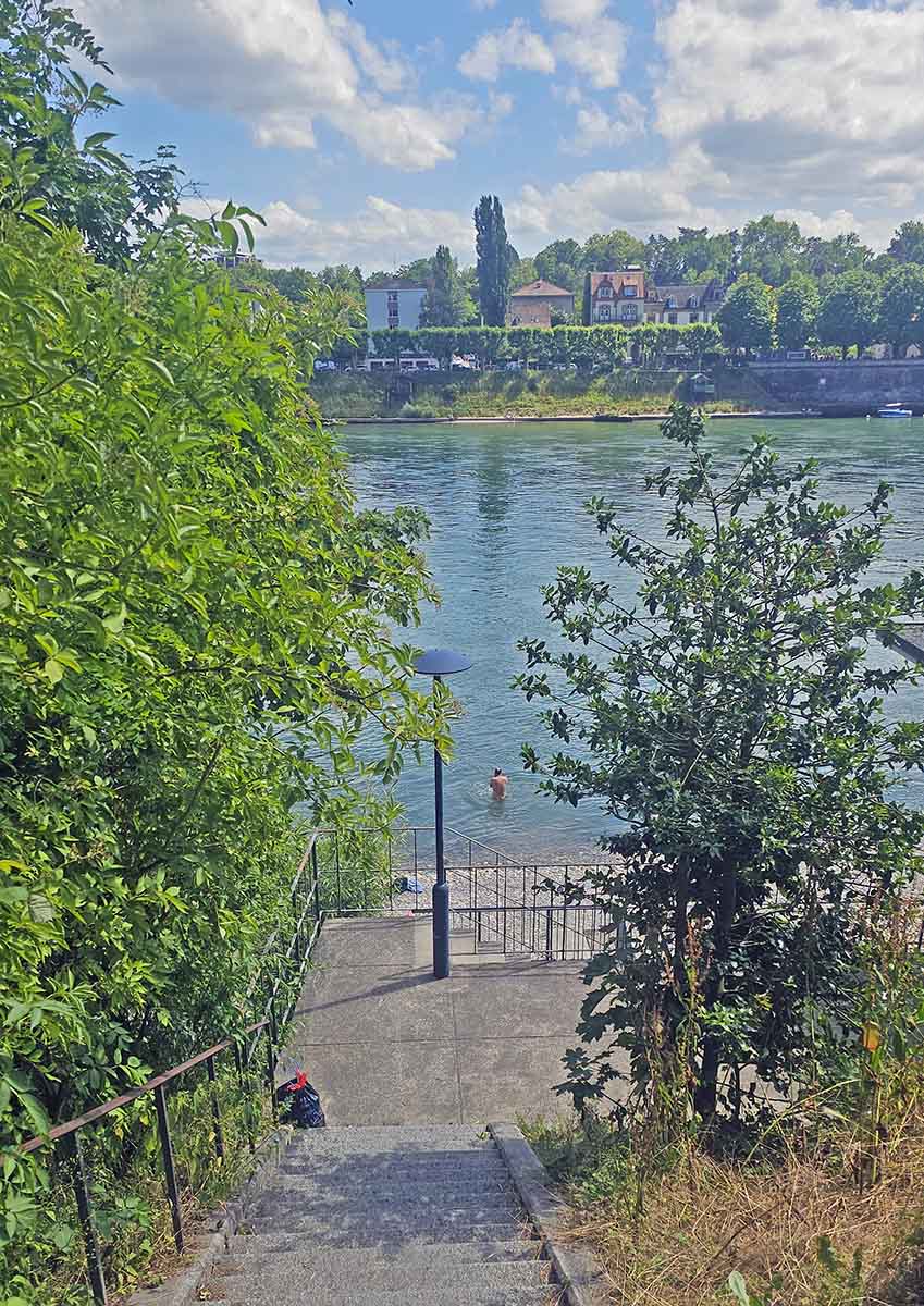 A nude man entering the Rhine River at Naturistenstrand, FKK beach in Basel City, Switzerland; photo by Ivan Kralj.